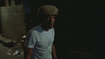 Movie still from “Alligator” (1980), directed by Lewis Teague – A man wearing a hat standing in the dark; Close Up shot, Low angle