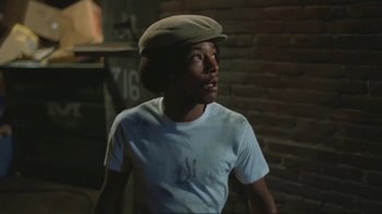 Movie still from “Alligator” (1980), directed by Lewis Teague – A young man wearing a hat and looking up; Medium shot, Low angle