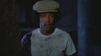 Movie still from “Alligator” (1980), directed by Lewis Teague – A person wearing a hat; Close Up shot, Low angle