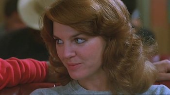 Movie still from “Alligator” (1980), directed by Lewis Teague – A woman with long red hair; Close Up shot, Over the shoulder angle
