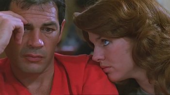 Movie still from “Alligator” (1980), directed by Lewis Teague – A man and a woman sitting next to each other; Close Up shot, Low angle