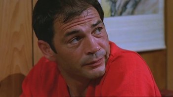 Movie still from “Alligator” (1980), directed by Lewis Teague – A person wearing a red shirt; Close Up shot, Low angle