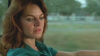 Movie still from “Alligator” (1980), directed by Lewis Teague – A person sitting in a car; Close Up shot, Low angle