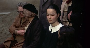 Movie still from “Amarcord” (1973), directed by Federico Fellini – A young girl in a nun's outfit sitting next to an older woman; Close Up shot, High angle
