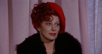 Movie still from “Amarcord” (1973), directed by Federico Fellini – A person wearing a red hat; Close Up shot, Over the shoulder angle