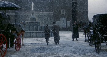 Movie still from “Amarcord” (1973), directed by Federico Fellini – A group of people walking in the snow; Extreme Wide shot, High angle