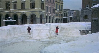 Movie still from “Amarcord” (1973), directed by Federico Fellini – Two people are standing in the middle of a snow covered area; Extreme Wide shot, High angle