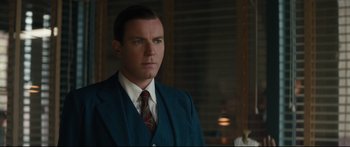 Movie still from “American Pastoral” (2016), directed by Ewan McGregor – A man in a suit and tie; Close Up shot, Over the shoulder angle