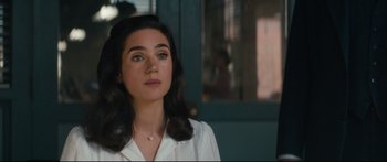 Movie still from “American Pastoral” (2016), directed by Ewan McGregor – A young woman in a white shirt looking to her left; Close Up shot, Over the shoulder angle
