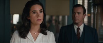 Movie still from “American Pastoral” (2016), directed by Ewan McGregor – A woman standing next to a man in a room; Close Up shot, Over the shoulder angle