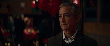 Movie still from “American Pastoral” (2016), directed by Ewan McGregor – An older man in a suit and tie looking to his left; Close Up shot, Over the shoulder angle