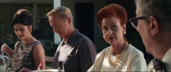 Movie still from “American Pastoral” (2016), directed by Ewan McGregor – An older man standing next to an older woman; Close Up shot, Over the shoulder angle