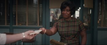 Movie still from “American Pastoral” (2016), directed by Ewan McGregor – An older black woman holding a piece of paper in her hand; Medium shot, Over the shoulder angle