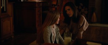 Movie still from “American Pastoral” (2016), directed by Ewan McGregor – Two women sitting at a table with a glass of milk; Medium shot, Over the shoulder angle