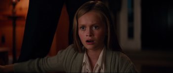 Movie still from “American Pastoral” (2016), directed by Ewan McGregor – A young girl with a surprised look on her face; Close Up shot, Over the shoulder angle