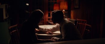 Movie still from “American Pastoral” (2016), directed by Ewan McGregor – A man and a woman sitting at a dinner table; Medium shot, Low angle