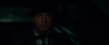 Movie still from “American Pastoral” (2016), directed by Ewan McGregor – A person wearing a suit and hat; Close Up shot, Low angle