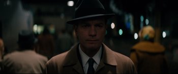 Movie still from “American Pastoral” (2016), directed by Ewan McGregor – A man wearing a hat and a coat; Close Up shot, Over the shoulder angle