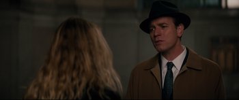 Movie still from “American Pastoral” (2016), directed by Ewan McGregor – A man wearing a hat and a coat talking to a woman wearing a hat; Close Up shot, Over the shoulder angle