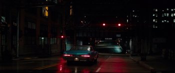 Movie still from “American Pastoral” (2016), directed by Ewan McGregor – A car is parked on the side of the road at night; Extreme Wide shot, High angle
