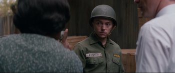 Movie still from “American Pastoral” (2016), directed by Ewan McGregor – A man in a military uniform talking on a phone; Close Up shot, Over the shoulder angle