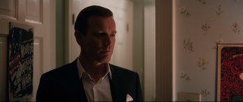 Movie still from “American Pastoral” (2016), directed by Ewan McGregor – A person wearing a suit and tie; Close Up shot, Over the shoulder angle