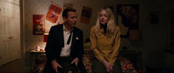 Movie still from “American Pastoral” (2016), directed by Ewan McGregor – A man and a woman sitting next to each other on a bed; Medium shot, Over the shoulder angle