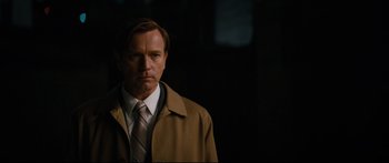 Movie still from “American Pastoral” (2016), directed by Ewan McGregor – A man wearing a brown coat and a tie; Close Up shot, Over the shoulder angle
