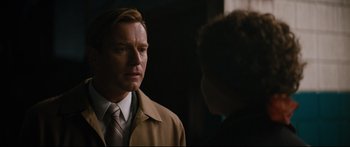 Movie still from “American Pastoral” (2016), directed by Ewan McGregor – A man wearing a suit and tie talking to another man wearing a suit and tie; Close Up shot, Over the shoulder angle