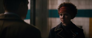 Movie still from “American Pastoral” (2016), directed by Ewan McGregor – A woman wearing a head scarf in front of another woman; Close Up shot, Over the shoulder angle