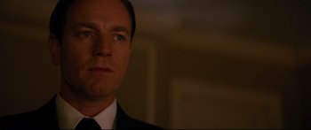 Movie still from “American Pastoral” (2016), directed by Ewan McGregor – A person wearing a suit and tie; Close Up shot, Over the shoulder angle