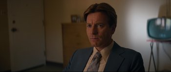 Movie still from “American Pastoral” (2016), directed by Ewan McGregor – A person wearing a suit and tie; Close Up shot, Over the shoulder angle