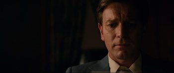 Movie still from “American Pastoral” (2016), directed by Ewan McGregor – A person wearing a suit and tie; Close Up shot, Low angle
