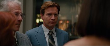 Movie still from “American Pastoral” (2016), directed by Ewan McGregor – A person wearing a suit and tie; Close Up shot, Over the shoulder angle