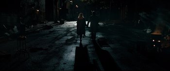 Movie still from “American Pastoral” (2016), directed by Ewan McGregor – Two people walking down a street at night; Wide shot, High angle