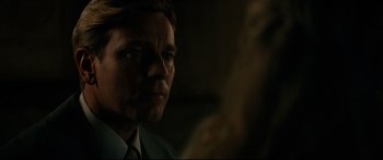 Movie still from “American Pastoral” (2016), directed by Ewan McGregor – A person wearing a suit and tie; Close Up shot, Over the shoulder angle