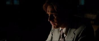 Movie still from “American Pastoral” (2016), directed by Ewan McGregor – A person wearing a suit and tie; Close Up shot, Over the shoulder angle