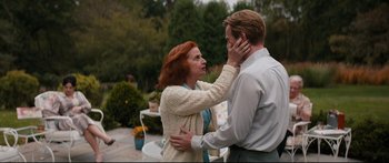 Movie still from “American Pastoral” (2016), directed by Ewan McGregor – A man and a woman are touching each other's hair; Medium shot, Over the shoulder angle