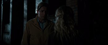 Movie still from “American Pastoral” (2016), directed by Ewan McGregor – A man and a woman standing next to each other in the dark; Medium shot, Over the shoulder angle