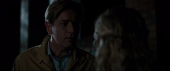 Movie still from “American Pastoral” (2016), directed by Ewan McGregor – A man and a woman are talking in a dark room; Close Up shot, Over the shoulder angle