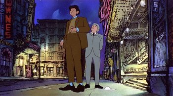Movie still from “American Pop” (1981), directed by Ralph Bakshi – Two men standing next to each other on a street; Wide shot, Low angle