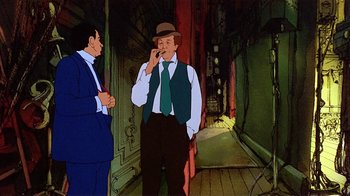 Movie still from “American Pop” (1981), directed by Ralph Bakshi – Two men are standing in a room with a building in the background; Medium shot, High angle