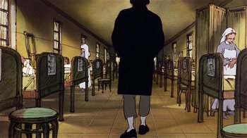 Movie still from “American Pop” (1981), directed by Ralph Bakshi – A man standing in front of rows of chairs in a room; Wide shot, High angle