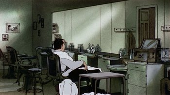 Movie still from “American Pop” (1981), directed by Ralph Bakshi – A man sitting at a table in a room; Wide shot, High angle