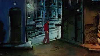 Movie still from “American Pop” (1981), directed by Ralph Bakshi – A man in a red shirt is standing by a street sign; Wide shot, High angle