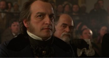 Movie still from “Amistad” (1997), directed by Steven Spielberg – A man in a suit and a man with a beard; Close Up shot, Low angle