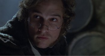 Movie still from “Amistad” (1997), directed by Steven Spielberg – A person wearing glasses; Close Up shot, Over the shoulder angle