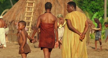 Movie still from “Amistad” (1997), directed by Steven Spielberg – A couple of people walking on a dirt road; Medium shot, Low angle