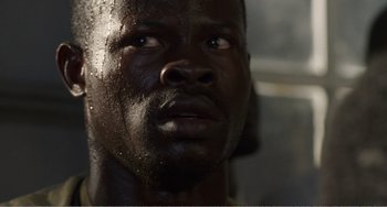 Movie still from “Amistad” (1997), directed by Steven Spielberg – A man's face in the dark; Close Up shot, Low angle