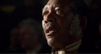 Movie still from “Amistad” (1997), directed by Steven Spielberg – An older man with a beard and a mustache; Close Up shot, Low angle